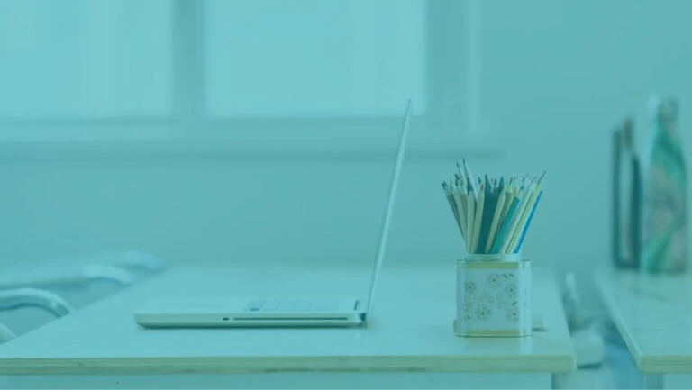 Laptop on a desk and pencil pot